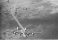 B-24 smoking in number two engine, note heavy flack